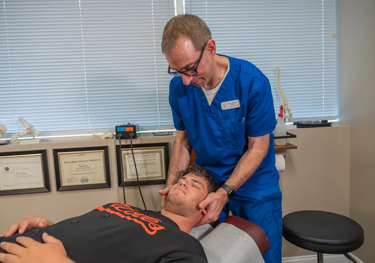 Dr. Paul Abosh performing a gentle neck adjustment at Towson Integrative Health in Towson